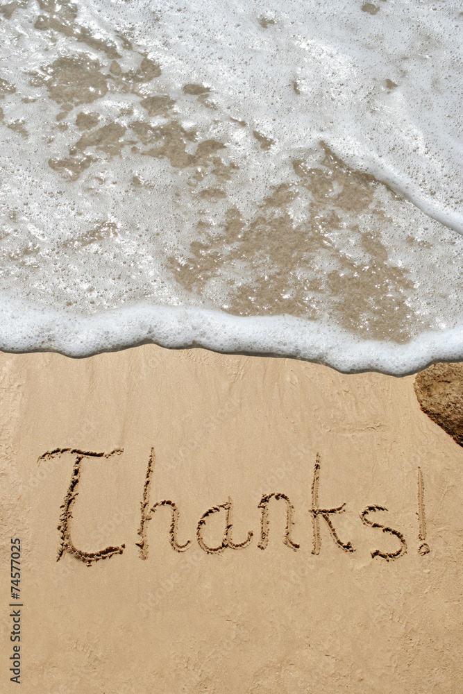 Conceptual thank you text in sand and water Conceptual thank you text in sand and water