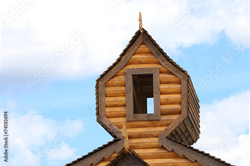 Part of roof of log wooden house with window © singulyarra