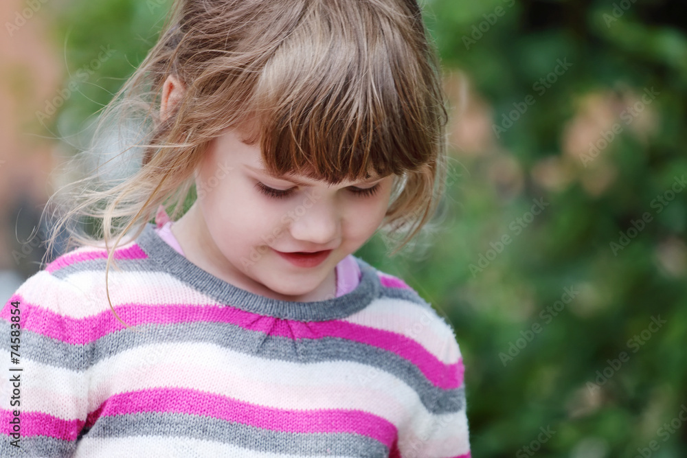 Portrait of young happy smiling girl in striped sweater Portrait of young happy smiling girl in striped sweater