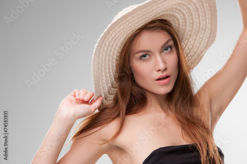 Beautiful girl with hat posing in studio