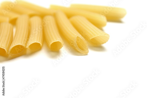 Some raw penne macaroni isolated on white background