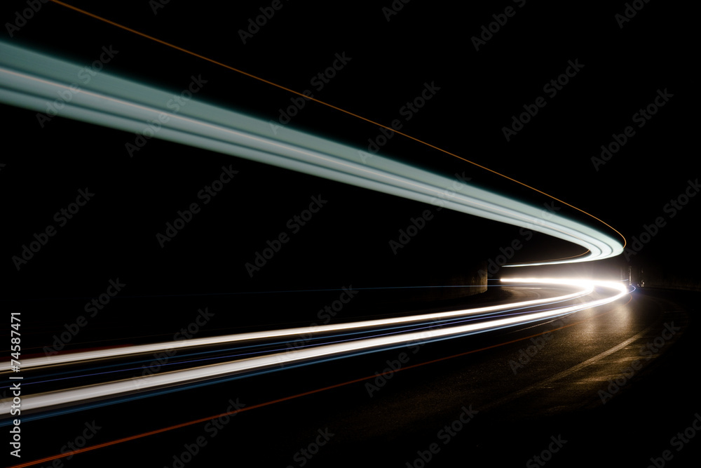 Abstract blue, yellow and white rays of light in a car tunnel