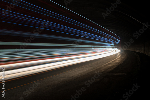 Abstract blue, yellow and white rays of light in a car tunnel
