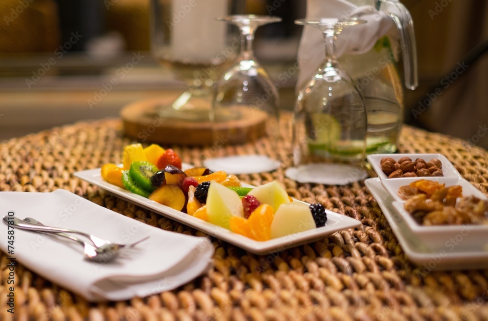 Plate with fresh fruits and refreshing drink on a table Plate with fresh fruits and refreshing drink on a table