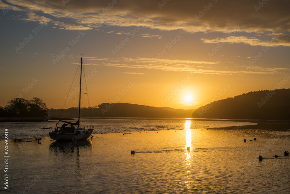 Sunrise on the river lynher with golden reflections