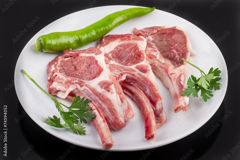 raw cutlet of lamb with vegetables raw cutlet of lamb with vegetables