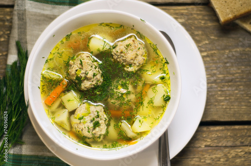 hot soup with meatballs and herbs