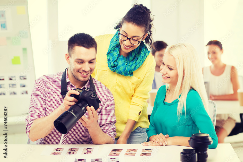 Fototapeta premium smiling team with photocamera working in office