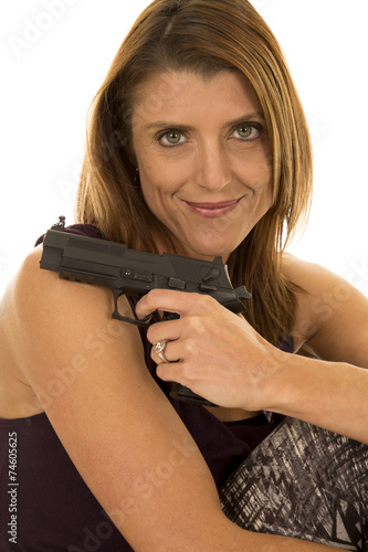 woman in tank top sit with gun look smile