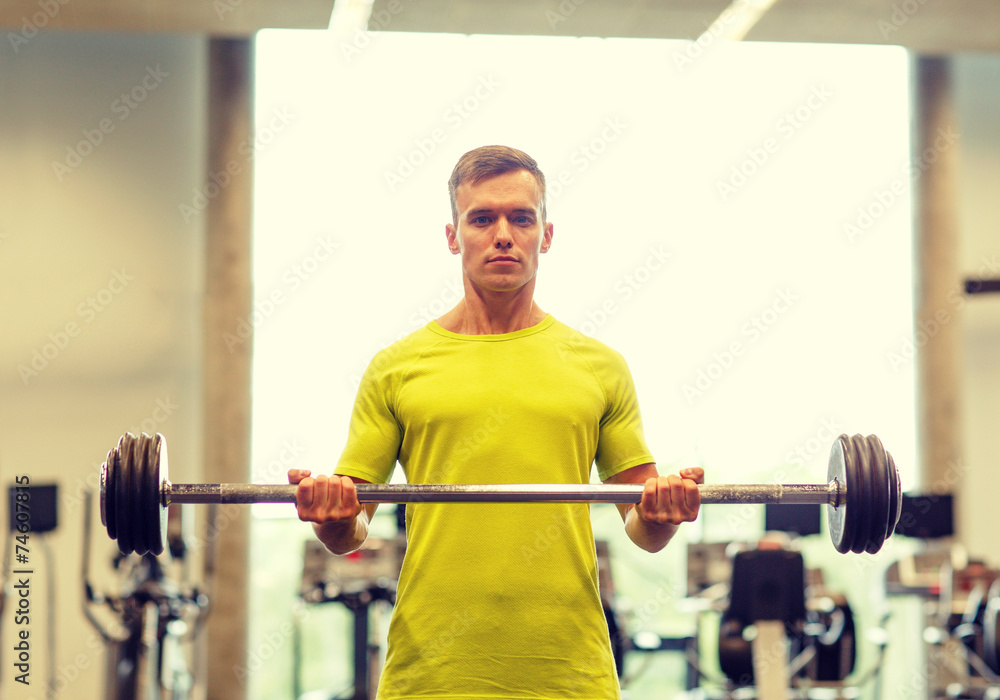 man doing exercise with barbell in gym man doing exercise with barbell in gym