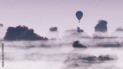 Aerial of hot air balloon flying over autumn mountain landscape