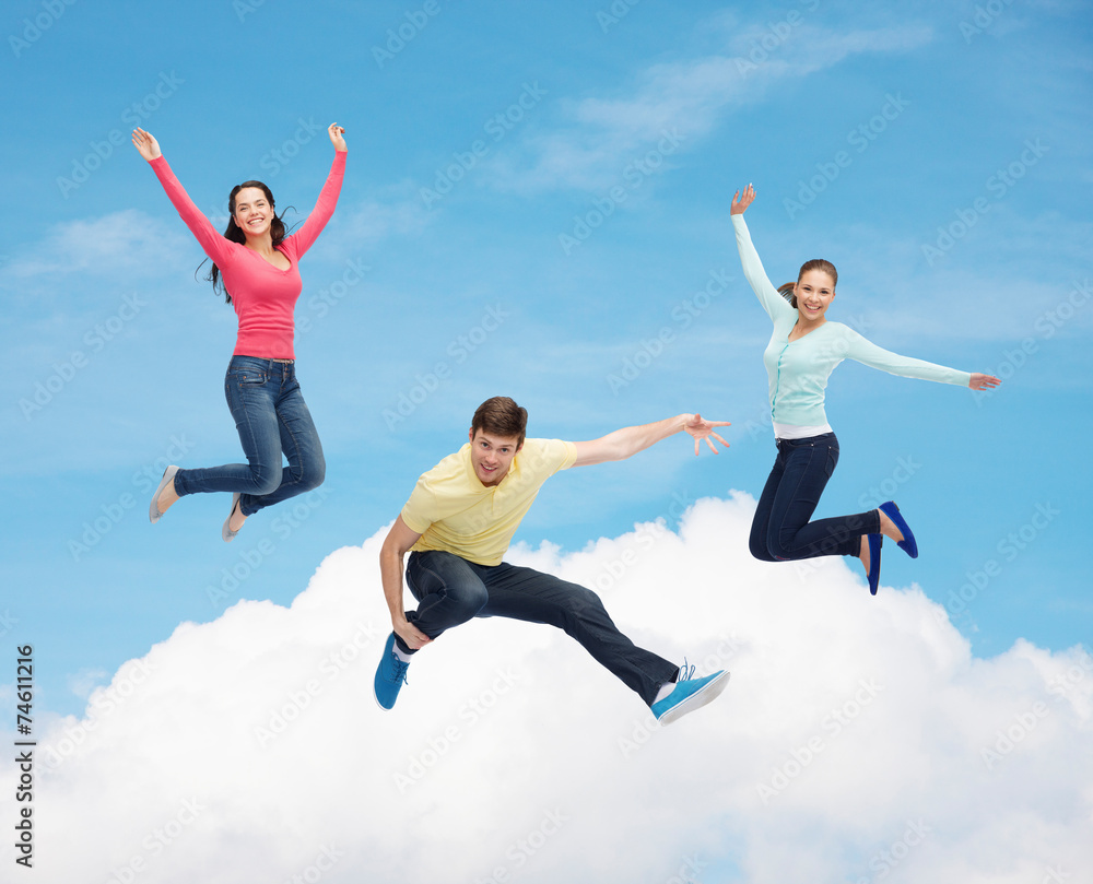 group of smiling teenagers jumping in air group of smiling teenagers jumping in air