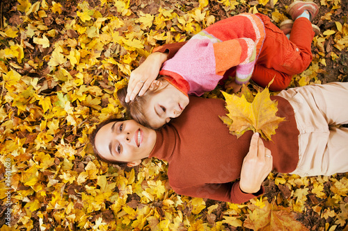 Tableau sur toile Mother and little daughter enjoying autumn day in a park