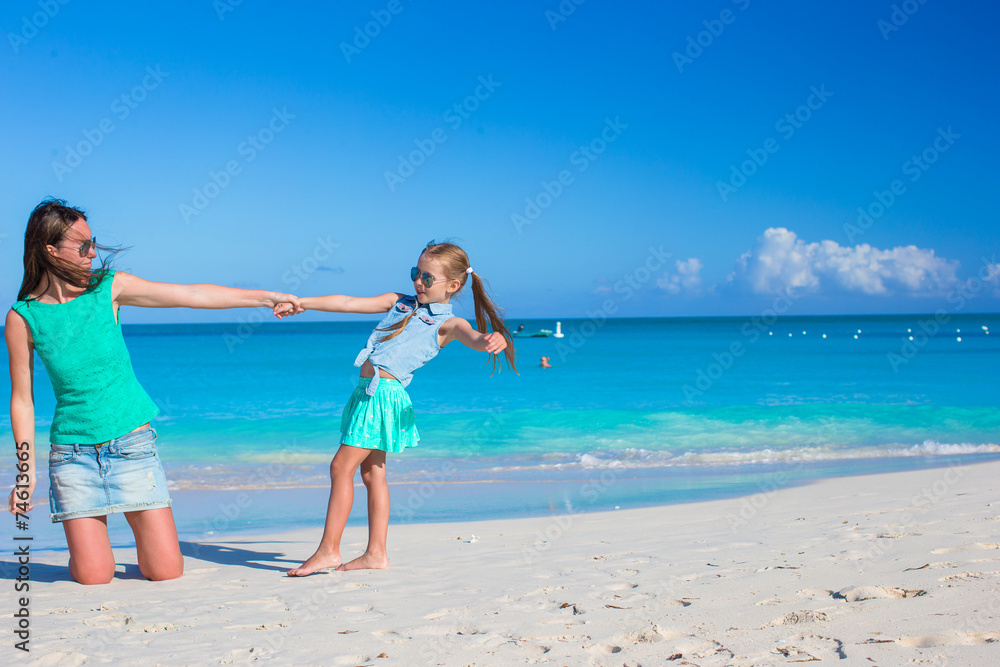 Young mother and adorable little daughter enjoy summer vacation