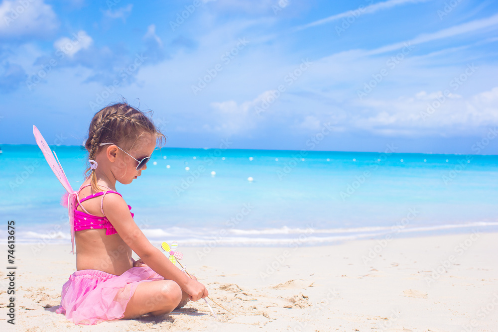 Adorable little girl with wings like butterfly on beach vacation Adorable little girl with wings like butterfly on beach vacation