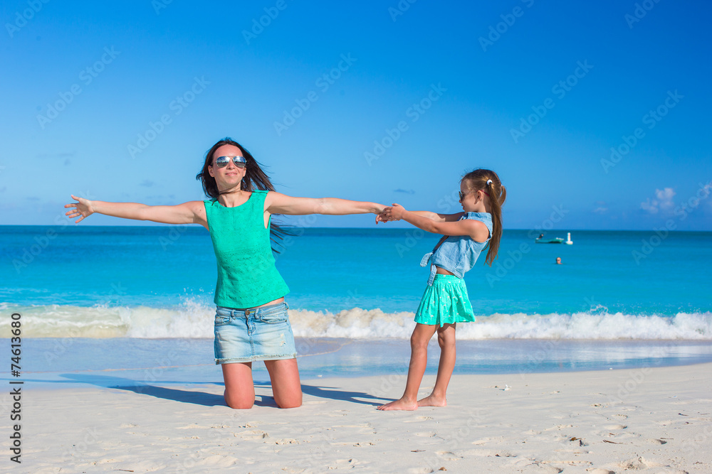 Young mother and adorable little daughter enjoy summer vacation
