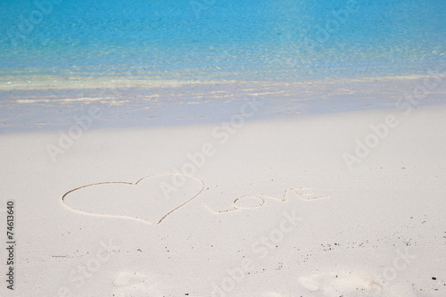 Love written on tropical beach white sand
