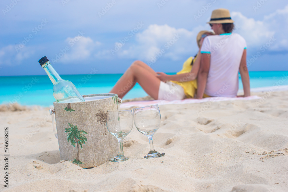 Bottle of white wine and two glasses background happy couple on Bottle of white wine and two glasses background happy couple on