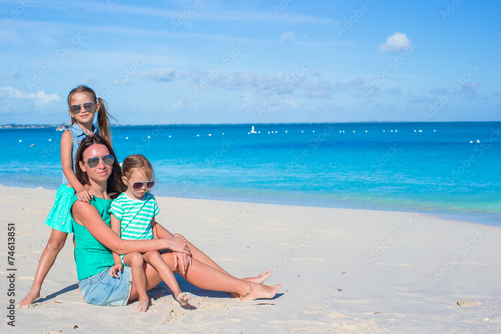 Little girls and happy mother during tropical beach vacation Little girls and happy mother during tropical beach vacation