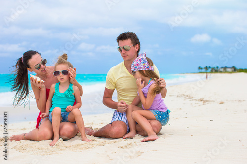Young happy family with two kids on summer vacation