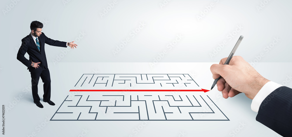 Business man looking at hand drawing solution for maze Business man looking at hand drawing solution for maze