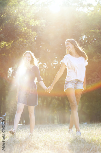 Two teenagers walking in the park