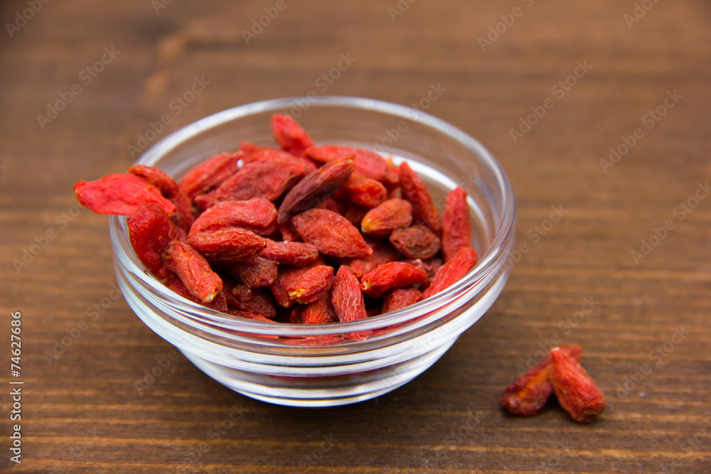 Goji berries in bowl on wooden table Goji berries in bowl on wooden table