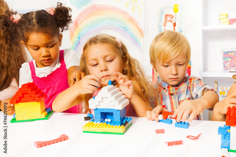 Fototapeta premium Group of kids playing with plastic blocks