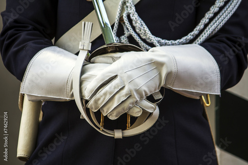 Close up view of a guarding police uniform hands with gloves. photo