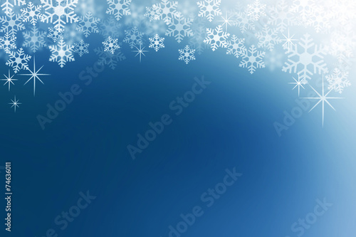 Snow flakes on midnight blue abstract winter background.