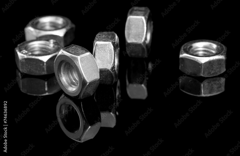 Metal nuts on black Metal nuts on black