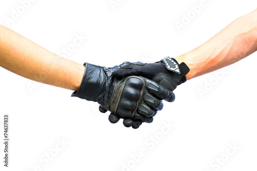 Two hands biker gloves meet in hand shake