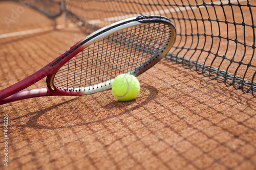 Close up of tennis racquet and ball on the clay tennis court  © pawel70