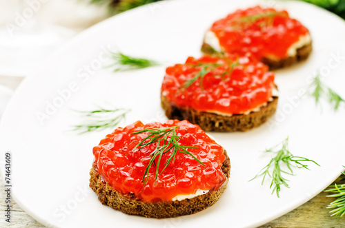 canape with red caviar and cream cheese