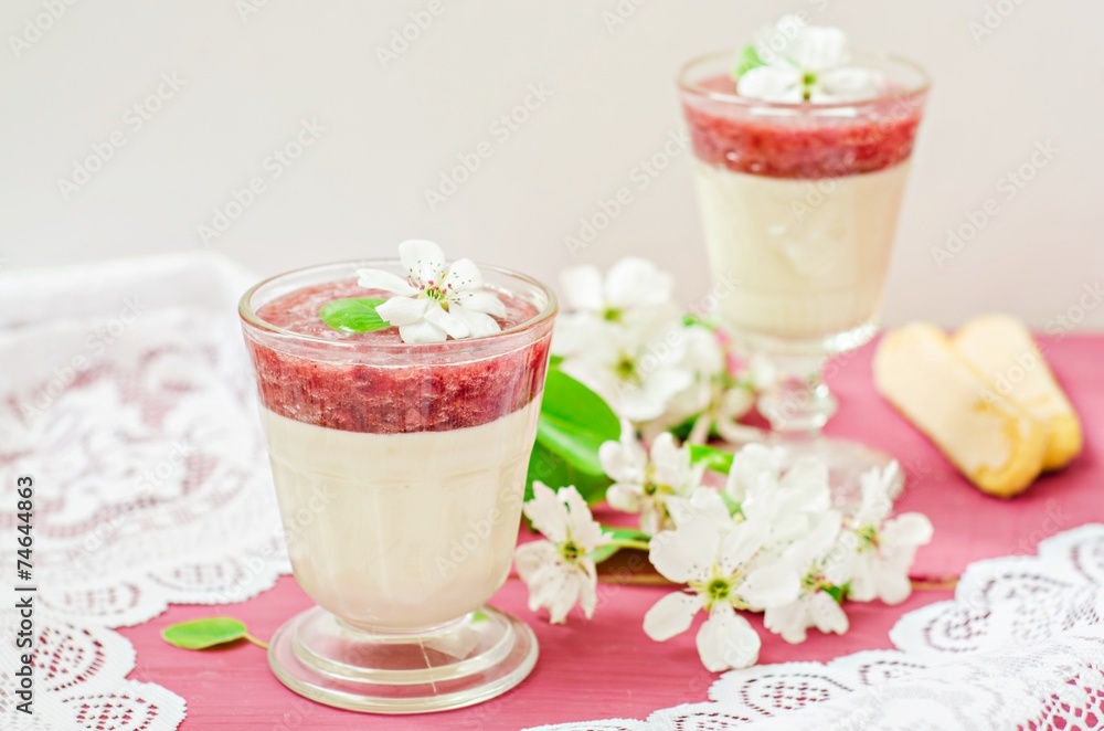 White chocolate dessert with strawberry mousse in glasses on spring background. Selective focus on flowers White chocolate dessert with strawberry mousse in glasses on spring background. Selective focus on flowers