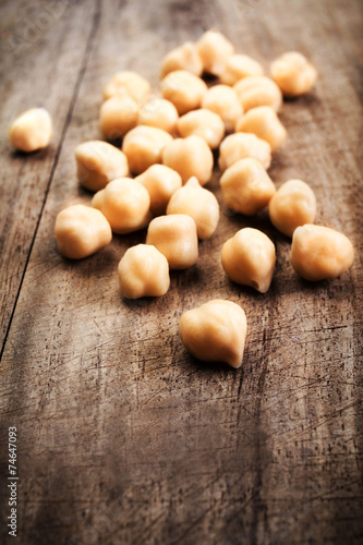 Golden Chickpeas over rustic wooden table close up. Traditiona