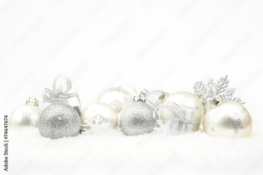 Silver christmas decoration on snow in line Silver christmas decoration on snow in line