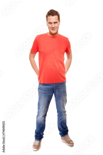 Young man guy red t-shirt jaens with hands in pockets isolated © Voyagerix