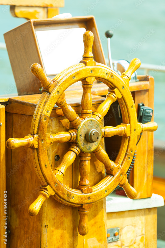 Yachting. Ship wooden steering wheel. Sailboat detail.