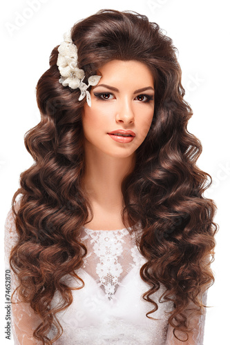 portrait of a beautiful brunette girl in white wedding dress