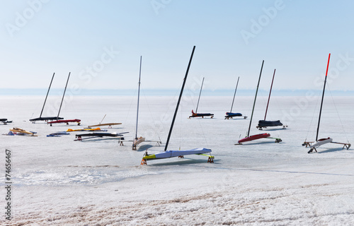 Ice boats in protective covers on ice of frozen Lake Baikal