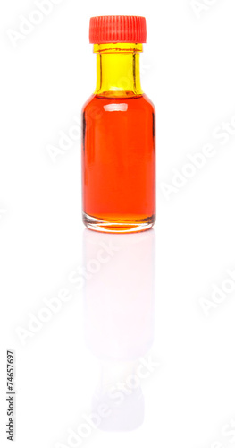Liquid orange food color additive over white background