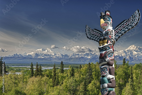 Mountain landscape with wooden totem pole 