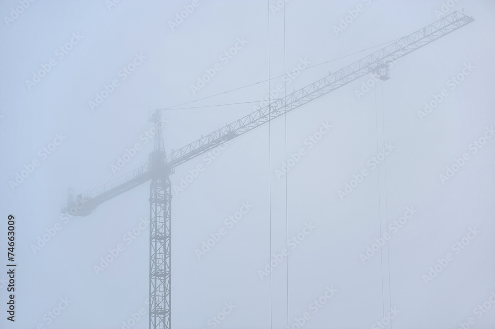 Construction crane in dense fog Construction crane in dense fog