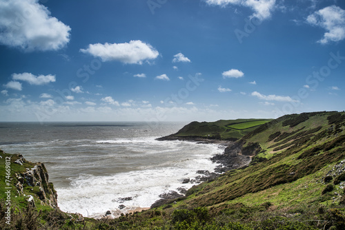 Summer landscape of Worm's Head and Rhosilli Bay in Wales