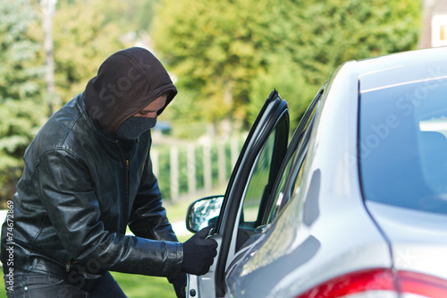 Thief stealing a car