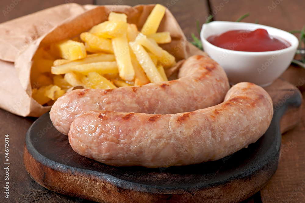 Chicken sausages grilled with a side dish of french fries Chicken sausages grilled with a side dish of french fries