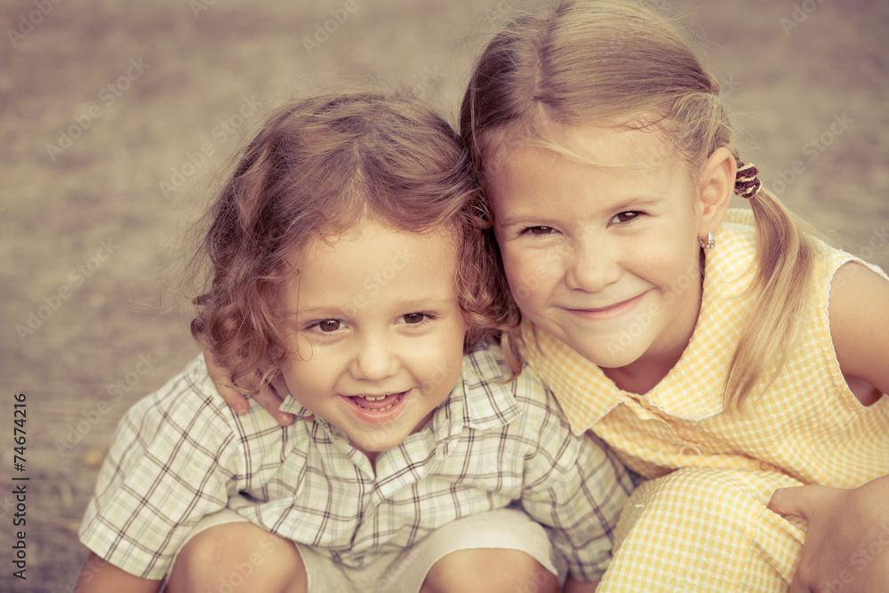 Happy kids sitting on the road. Concept Brother And Sister Toget Happy kids sitting on the road. Concept Brother And Sister Toget