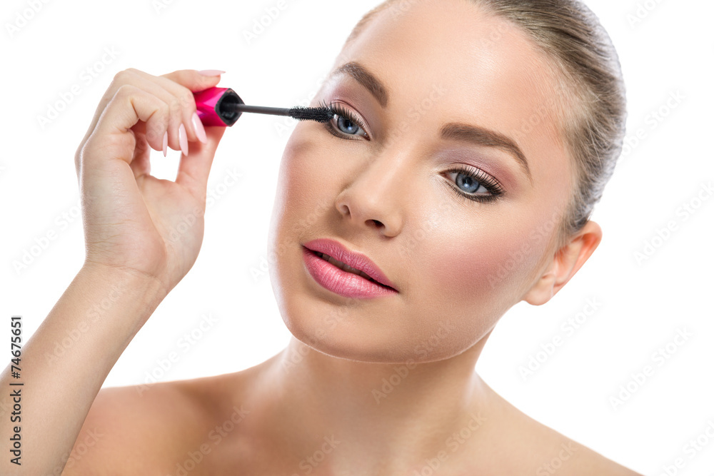 Young woman  applying mascara