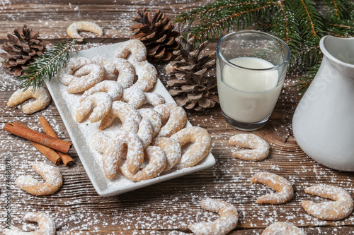 Vanille cookies and milk on a wooden table